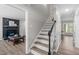 View of the staircase with wooden steps and a black railing, connecting the living spaces at 3 Haggis Ct, Durham, NC 27705
