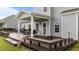 Spacious back deck with covered area, outdoor furniture, and grill perfect for entertaining and enjoying the outdoors at 30 Sunbury Ct, Zebulon, NC 27597