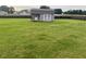 Backyard featuring a charming storage shed with double doors and a secure fenced perimeter at 30 Sunbury Ct, Zebulon, NC 27597