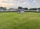 Backyard featuring a charming storage shed with double doors and a secure fenced perimeter at 30 Sunbury Ct, Zebulon, NC 27597