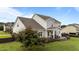 Wide backyard with a wooden deck and green grass at 30 Sunbury Ct, Zebulon, NC 27597