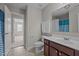 Bathroom with a single sink vanity, toilet, and view into another room at 30 Sunbury Ct, Zebulon, NC 27597