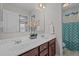 Bathroom featuring a double vanity, white sinks, and a decorative shower curtain at 30 Sunbury Ct, Zebulon, NC 27597