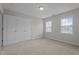 Bedroom featuring carpet, windows, and a double-door closet at 30 Sunbury Ct, Zebulon, NC 27597