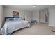 Bright bedroom with neutral walls, carpeted floors and a painting of a scenic pier at 30 Sunbury Ct, Zebulon, NC 27597