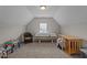 Attic bonus room with a tanning bed, window, hardwood table and wicker chair at 30 Sunbury Ct, Zebulon, NC 27597