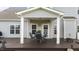 Cozy covered deck area with outdoor furniture at 30 Sunbury Ct, Zebulon, NC 27597