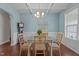 Formal dining room with wainscoting, blue walls, and wood floors at 30 Sunbury Ct, Zebulon, NC 27597