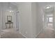 Bright and inviting hallway featuring neutral walls and carpet leading to various rooms at 30 Sunbury Ct, Zebulon, NC 27597