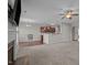 Open concept living room with a fireplace, television, ceiling fan, windows, and a kitchen bar at 30 Sunbury Ct, Zebulon, NC 27597