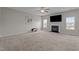 Cozy living room with a fireplace, TV and plush carpet, perfect for relaxing and entertaining at 30 Sunbury Ct, Zebulon, NC 27597