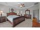 A well-lit main bedroom showcases a decorative bed frame and access to the main bathroom at 30 Sunbury Ct, Zebulon, NC 27597