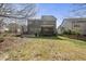 Large backyard with a well maintained lawn, a wooden fence, and a covered porch for outdoor relaxation at 300 Redhill Rd, Holly Springs, NC 27540