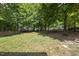 A backyard with a lawn and a wooden fence that overlooks other houses at 300 Redhill Rd, Holly Springs, NC 27540