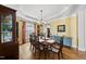 Elegant dining room with a chandelier, table seating for six, and stylish decor at 300 Redhill Rd, Holly Springs, NC 27540