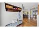Inviting entryway with hardwood floors, coat rack, and storage bench, leading to dining room at 300 Redhill Rd, Holly Springs, NC 27540