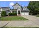 Charming two-story home with a two-car garage and well-manicured front lawn and landscaping at 300 Redhill Rd, Holly Springs, NC 27540