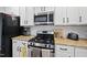 Close up shot of kitchen showcasing stainless steel gas range and other modern appliances at 300 Redhill Rd, Holly Springs, NC 27540