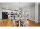 Eat-in kitchen with bright white cabinets, stainless steel appliances, and a cozy breakfast table at 300 Redhill Rd, Holly Springs, NC 27540