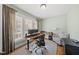 Bright office space featuring a large window, desk, and comfortable chair at 300 Redhill Rd, Holly Springs, NC 27540
