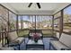 Relaxing screened porch with comfortable wicker furniture and blue rug, great for enjoying the outdoors at 300 Redhill Rd, Holly Springs, NC 27540