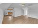 Attic space featuring wood-look floors and an open doorway to a kitchen at 302 Hester St, Knightdale, NC 27545