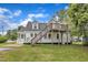 Exterior view of the home's backyard, showcasing the wooden deck and stairs at 302 Hester St, Knightdale, NC 27545