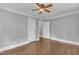 Bedroom with hardwood floors, ceiling fan, and doors leading to other rooms at 302 Hester St, Knightdale, NC 27545