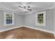 Bedroom with hardwood floors, neutral paint, and two windows at 302 Hester St, Knightdale, NC 27545