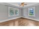 Bright bedroom features hardwood floors, crown molding, and plenty of natural light from multiple windows at 302 Hester St, Knightdale, NC 27545