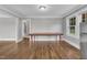 Dining area featuring hardwood floors, natural light, and large wooden table at 302 Hester St, Knightdale, NC 27545