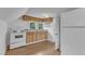 Cozy attic kitchen with an oven, refrigerator, wooden cabinets, and natural light at 302 Hester St, Knightdale, NC 27545