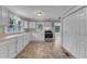 Bright kitchen features ample white cabinets, stainless steel range, and neutral countertops at 302 Hester St, Knightdale, NC 27545