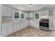 Eat-in kitchen with updated white cabinets, stainless range, and many windows at 302 Hester St, Knightdale, NC 27545