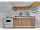 Efficient kitchen with white appliances, wood cabinets, sink, and countertop at 302 Hester St, Knightdale, NC 27545