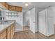 View of the kitchen features plenty of countertop space, a refrigerator, and white walls at 302 Hester St, Knightdale, NC 27545