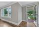 Sunlit living area with hardwood floors, neutral walls, and view of front yard at 302 Hester St, Knightdale, NC 27545