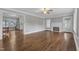 Open-concept living room with hardwood floors, fireplace, and view into the kitchen at 302 Hester St, Knightdale, NC 27545