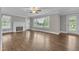 Spacious living room featuring a decorative fireplace, hardwood floors, and large windows at 302 Hester St, Knightdale, NC 27545