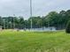 Community tennis courts surrounded by tall trees and well-maintained green space at 302 Hester St, Knightdale, NC 27545
