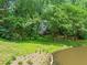 Beautiful backyard with lush greenery and waterfront views offer a peaceful retreat at 304 W Kirkfield Dr, Cary, NC 27518
