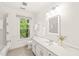 Bright bathroom with a soaking tub, large window, and a vanity with ample counter space at 304 W Kirkfield Dr, Cary, NC 27518