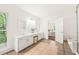 Well-lit bathroom featuring dual vanities, tile flooring, and a view into the main bedroom at 304 W Kirkfield Dr, Cary, NC 27518