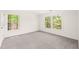 Bedroom featuring neutral carpet and large windows at 304 W Kirkfield Dr, Cary, NC 27518