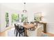 Dining room featuring a bay window offering natural light and an elegant light fixture at 304 W Kirkfield Dr, Cary, NC 27518