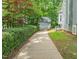 Long driveway leads to a detached garage, surrounded by mature landscaping at 304 W Kirkfield Dr, Cary, NC 27518