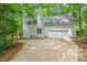 Two-story home features a two-car garage, grey siding, and black shutters at 304 W Kirkfield Dr, Cary, NC 27518