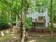 Multi-level deck and wooded surroundings offer perfect spaces for outdoor enjoyment at 304 W Kirkfield Dr, Cary, NC 27518