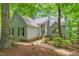Inviting home exterior with manicured landscaping, a welcoming entrance, and a peaceful wooded backdrop at 304 W Kirkfield Dr, Cary, NC 27518