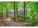 Charming home featuring a stone walkway and lush, mature landscaping, surrounded by mature trees at 304 W Kirkfield Dr, Cary, NC 27518